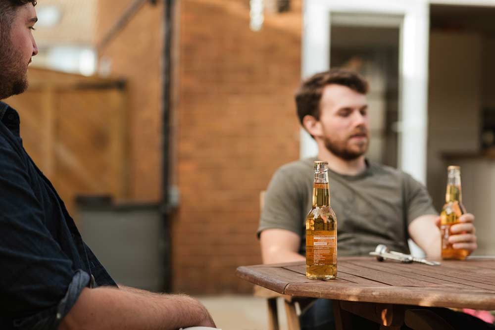 Men having beer during meeting in outdoor terrace