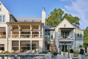 A large house featuring a swimming pool and a spacious patio area for outdoor relaxation and entertainment.